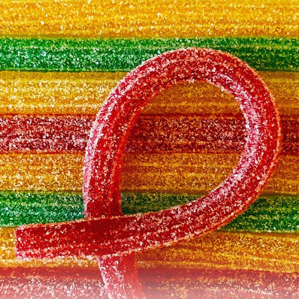 Close-up of sour straw candy showing pink sugar coating