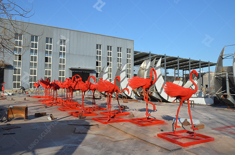 The red color paint is applied to red Flamingo sculptures.