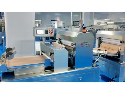 Two consecutive main sheeters calibrating the whole grain dough band to exact target thickness.